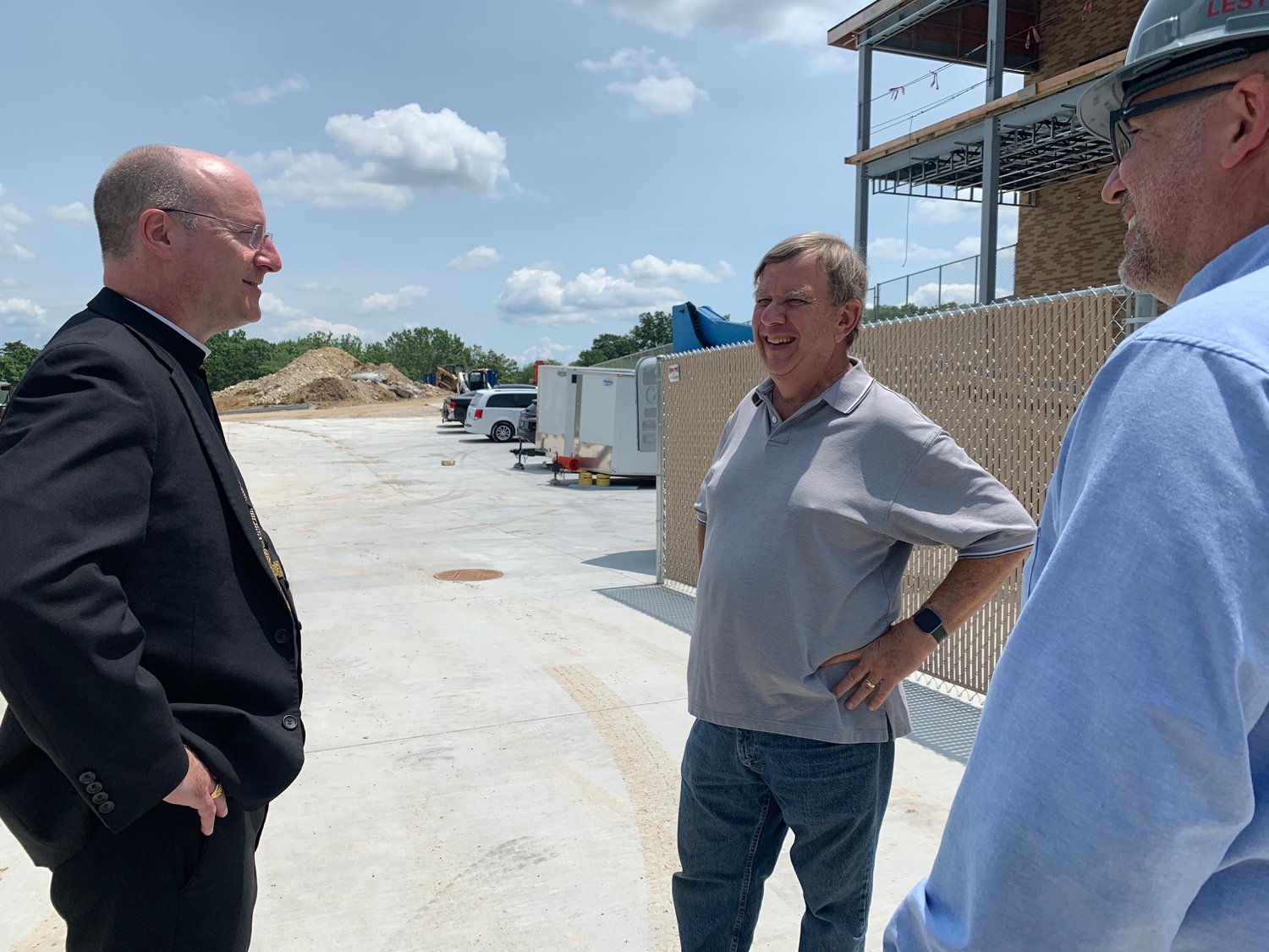 Bishop W. Shawn McKnight, Helias Catholic High School President John Knight and Catholic Charities of Central and Northern Missouri Executive Director Dan Lester tour the construction site of CCCNMO’s new health and social services center July 16.